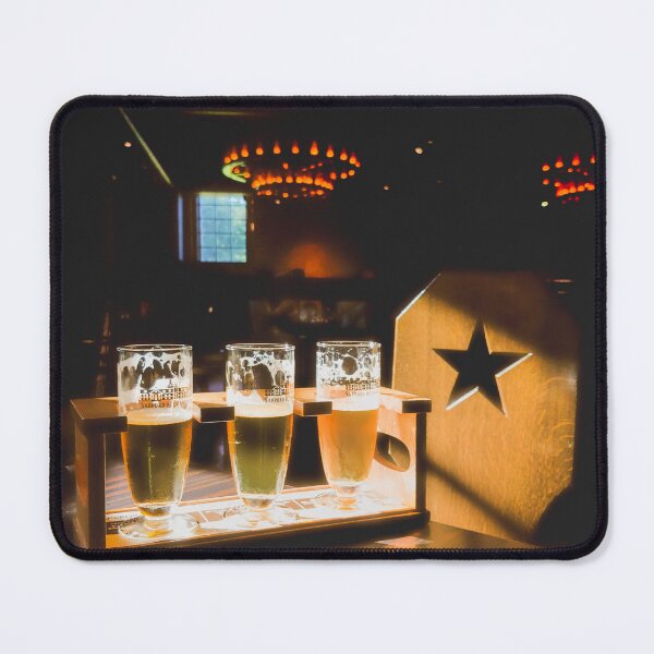 Item preview, A moody shot of three beer glasses filled with different colored beers on a wooden table designed and sold by BARTISTA DESIGN.