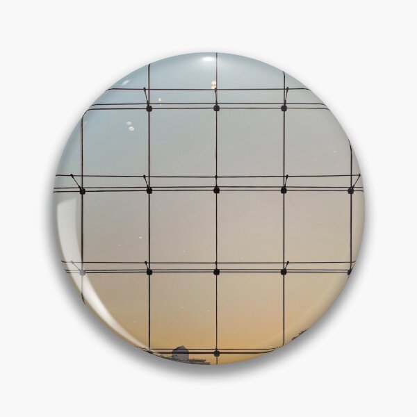 Item preview, A shot through a grid-like glass structure, revealing a cityscape at dusk. The sky transitions from a pale blue at the top to a warm orange glow near the horizon. designed and sold by BARTISTA DESIGN.