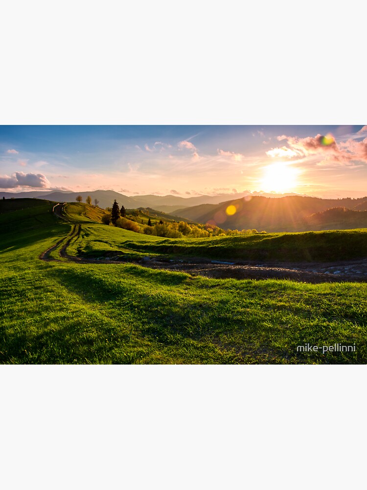 Thumbnail 3 of 3, Sticker, winding road along the grassy rural hill at sunset designed and sold by mike-pellinni.