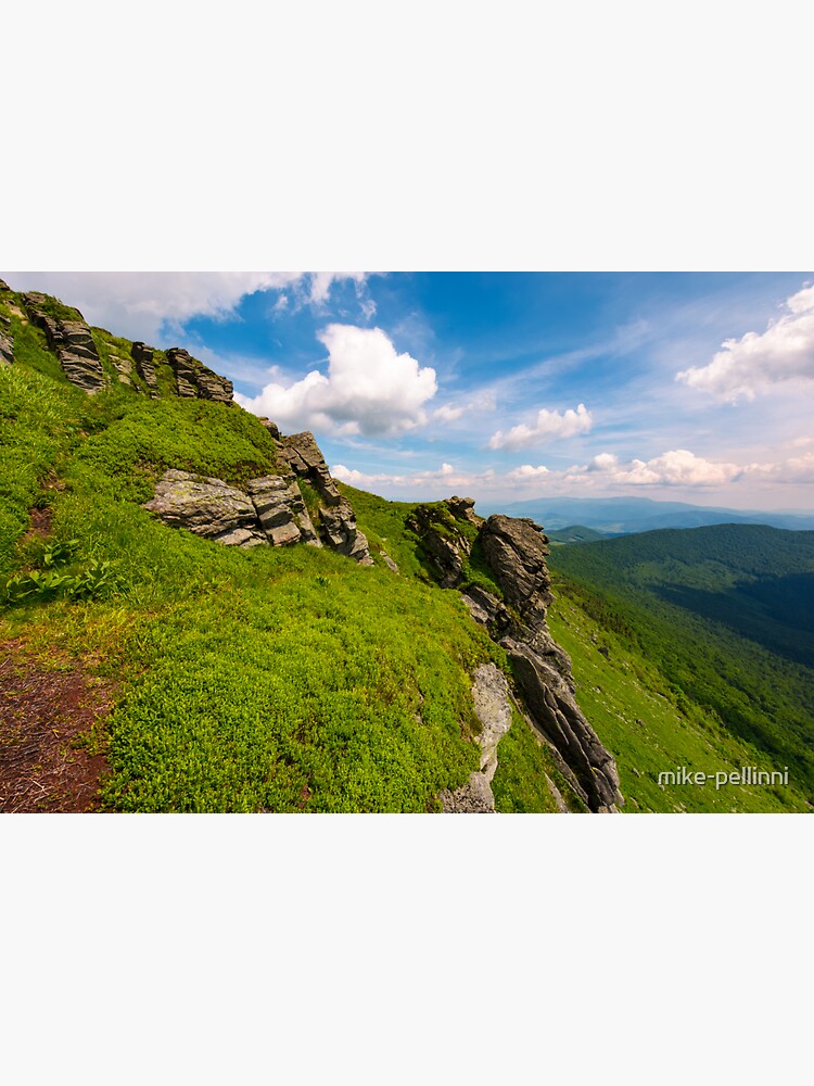 grassy hillside with boulders by mike-pellinni
