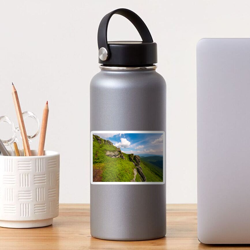 grassy hillside with boulders Sticker