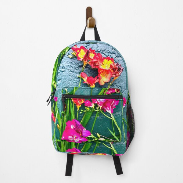 Item preview, Contrasting Colorful flowers exploding in brightness against a teal color cement wall designed and sold by Nomad Nikki – Abstract Fluid Artist & Full-Time Traveler.