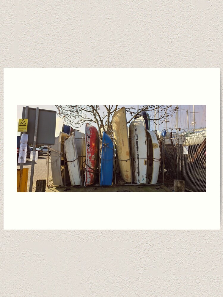 Thumbnail 1 of 3, Art Print, Dry Stack at the Creek boat hulls along the UK coast by Blink Friction designed and sold by taletellerclub.