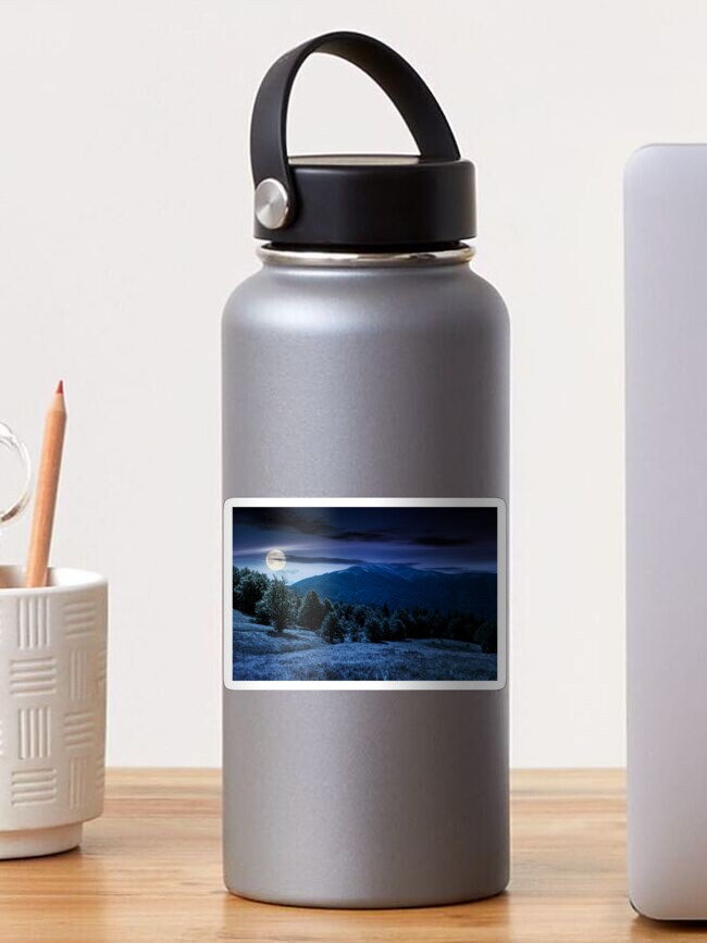 Thumbnail 1 of 3, Sticker, forest on grassy meadows in mountains at night designed and sold by mike-pellinni.