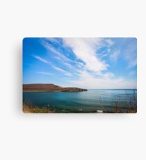 Cliff on spring time with the deep blue sea and sky with clouds Canvas Print