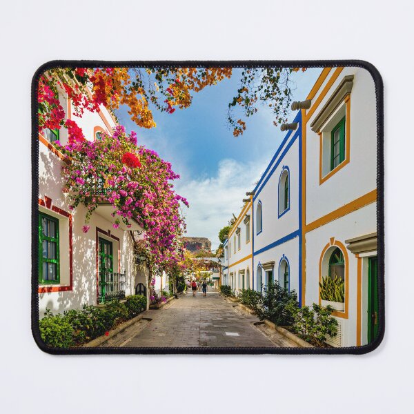 Item preview, Street with blooming flowers in Puerto de Mogan, Gran Canaria, Spain. Favorite vacation place for tourists and locals on island. Puerto de Mogan with lots of bougainvillea flowers, Canary Island. designed and sold by Framed Horizons.