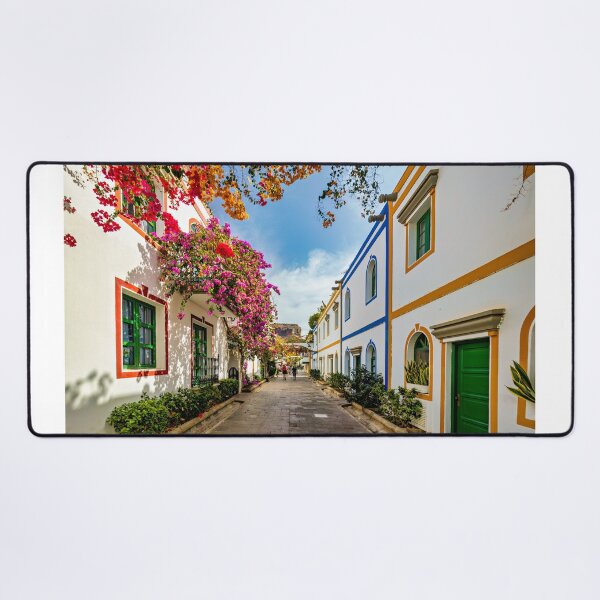 Item preview, Street with blooming flowers in Puerto de Mogan, Gran Canaria, Spain. Favorite vacation place for tourists and locals on island. Puerto de Mogan with lots of bougainvillea flowers, Canary Island. designed and sold by Framed Horizons.
