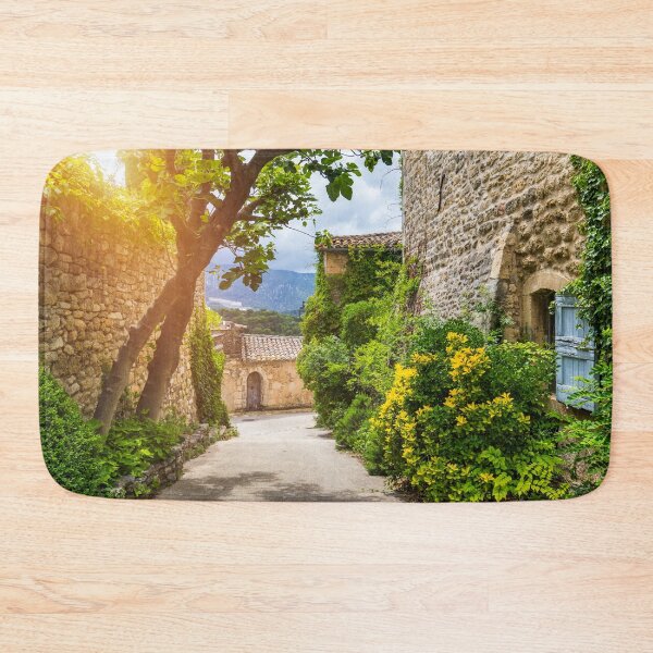 Item preview, Charming street in quaint Menerbes village with colorful buildings and vibrant flowers. Village of Menerbes (Most Beautiful Village in France) in the Luberon mountains, France, Luberon, Vaucluse. designed and sold by Framed Horizons.
