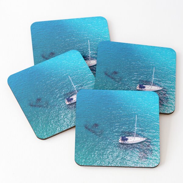 Item preview, Yacht anchoring in crystal clear turquoise water in front of the tropical island, alternative lifestyle, living on a boat. Aerial view of yacht at anchor on turquoise water, showing luxury, wealth. designed and sold by Framed Horizons.