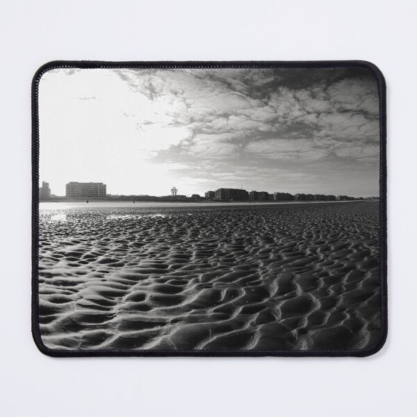 Item preview, Vast Sandy Beach With City Skyline Under Clear Blue Sky in black and white designed and sold by FotoMahieu.