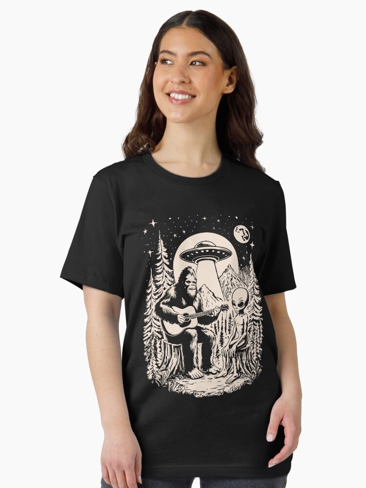 Thumbnail 2 of 7, Essential T-Shirt, Bigfoot Playing Guitar With Alien UFO Vintage Camping designed and sold by CutenessKlub.