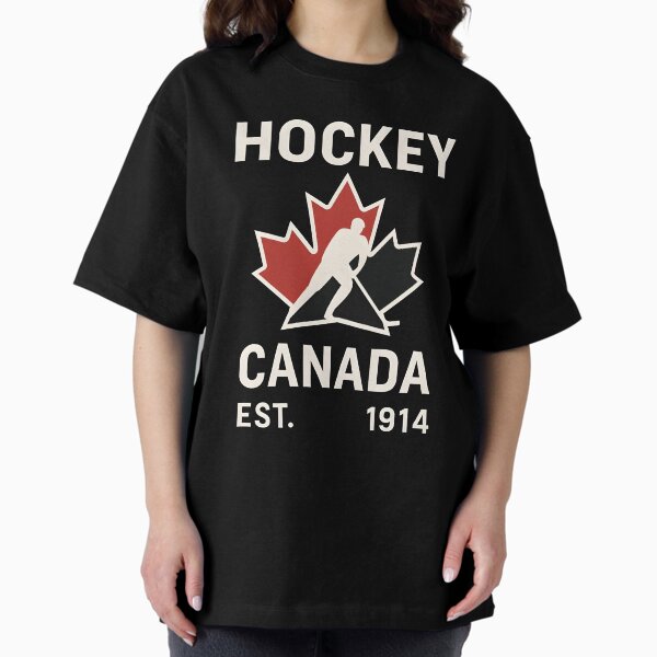 Vista previa del artículo con la obra «Camiseta de Hockey Canadá EST. 1914: Camiseta clásica de hockey vintage blanca sobre negra», diseñado y vendido por WAUZ.