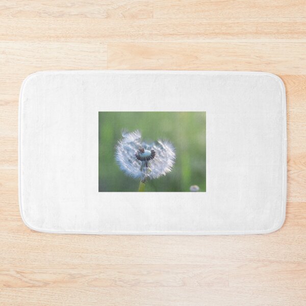 Item preview, Dandelion with seeds blowing away in the wind across a clear greenery designed and sold by Teqmi-images.