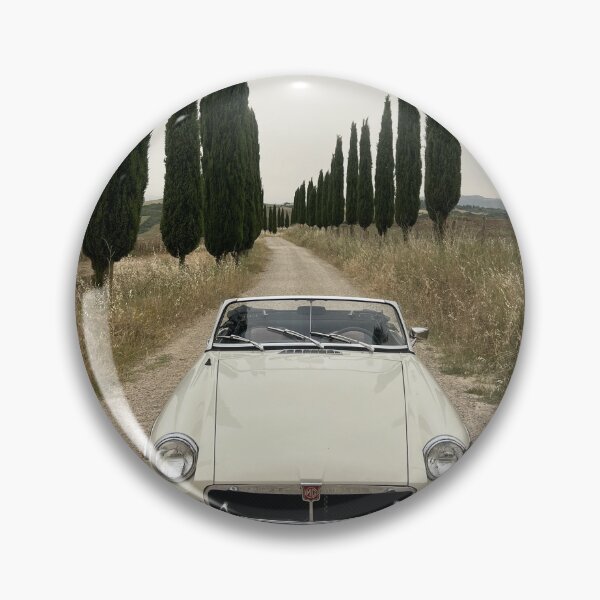 Item preview, MG MGB ina a field in Tuscany, surrounded by cypress, italian style travel car designed and sold by SpaceCars.