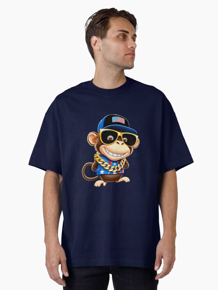 Aperçu 1 sur 7. T-shirt oversize avec l'œuvre whimsical cartoon monkey, with a mischievous grin and bright créée et vendue par 1onemarket.