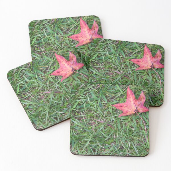 Item preview, a lone red leaf in the green grass designed and sold by OzzyluArt.