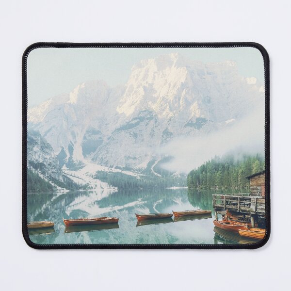 Item preview, Dolomites, Italy I Lago di Braies lake with its wooden cabin and boats in front of the snow mountain from morning mist fog to the moody aesthetic atmosphere of sunrise pastel light in misty forest designed and sold by Julie Travel Photography.