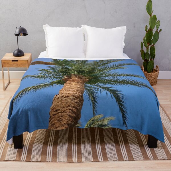 Item preview, date palm growing against blue sky designed and sold by IgorKovalenko.