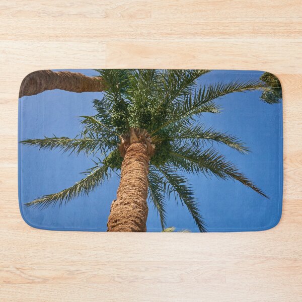 Item preview, date palm growing against blue sky designed and sold by IgorKovalenko.