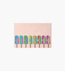 Row of rainbow-colored icecream lollies Art Board