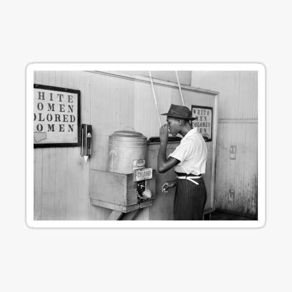 Negro drinking at Colored water cooler in streetcar terminal