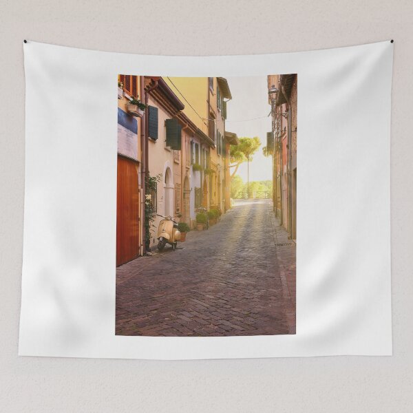 Item preview, Cobblestone street with scooter and old houses in Rimini, Italy designed and sold by goceris.