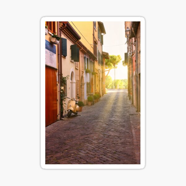 Item preview, Cobblestone street with scooter and old houses in Rimini, Italy designed and sold by goceris.