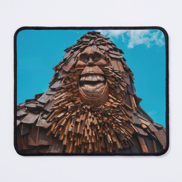 Item preview, Smiling Bigfoot Wood Sculpture Against Blue Sky designed and sold by MichaelPictures.