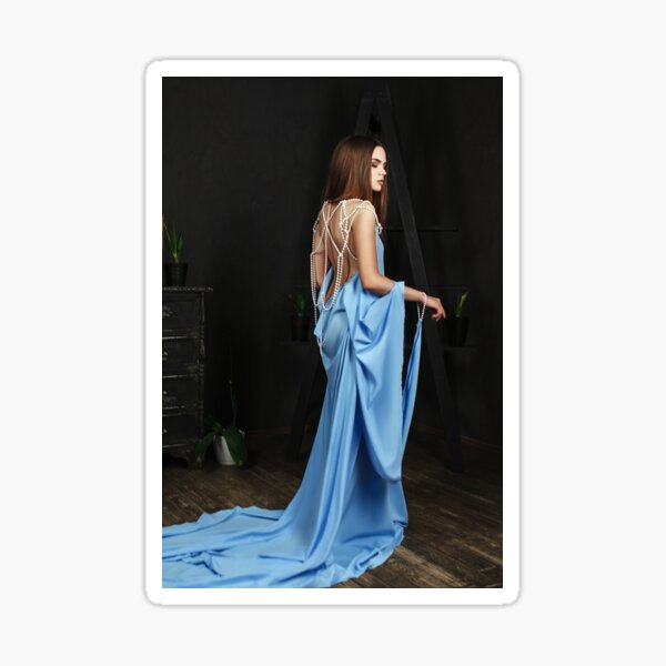 Beautiful model wearing light blue dress is posing in a studio Sticker