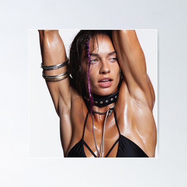 Beautiful sexy gym woman posing with her arms up showing her armpits  sweating