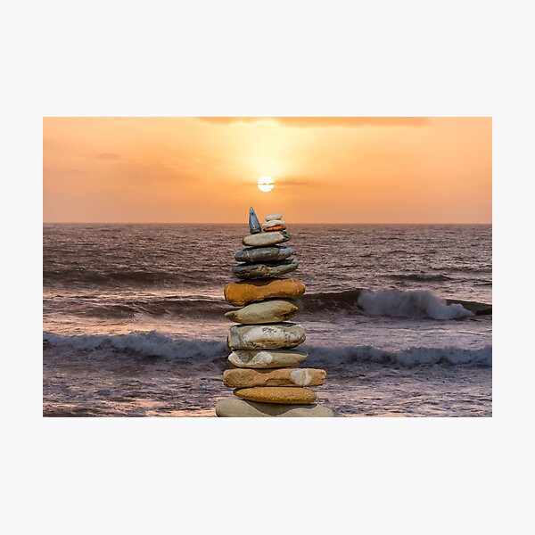 Stone Stacking on an Italian Beach at Sunset Photographic Print