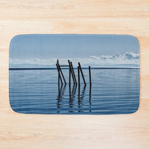 Item preview, Wooden structure in the ocean - mountain silhouette in the background designed and sold by Michaelerch.