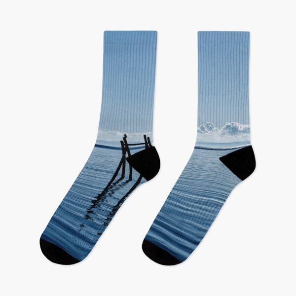 Item preview, Wooden structure in the ocean - mountain silhouette in the background designed and sold by Michaelerch.