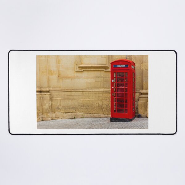 Item preview, Classic Red Telephone Booth Against Historic Stone Wall designed and sold by Nmallia.
