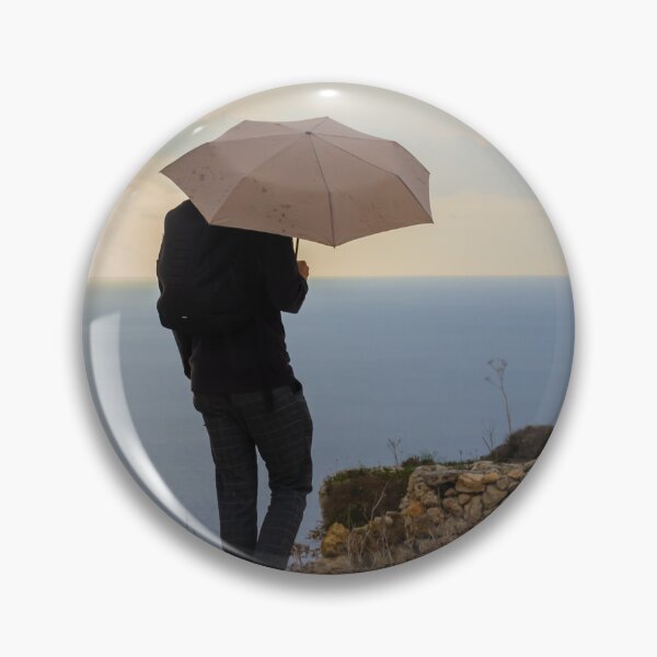 Item preview, An unrecognizable person with an Umbrella Standing by Ocean on an Overcast Day designed and sold by Nmallia.