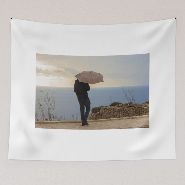 Item preview, An unrecognizable person with an Umbrella Standing by Ocean on an Overcast Day designed and sold by Nmallia.