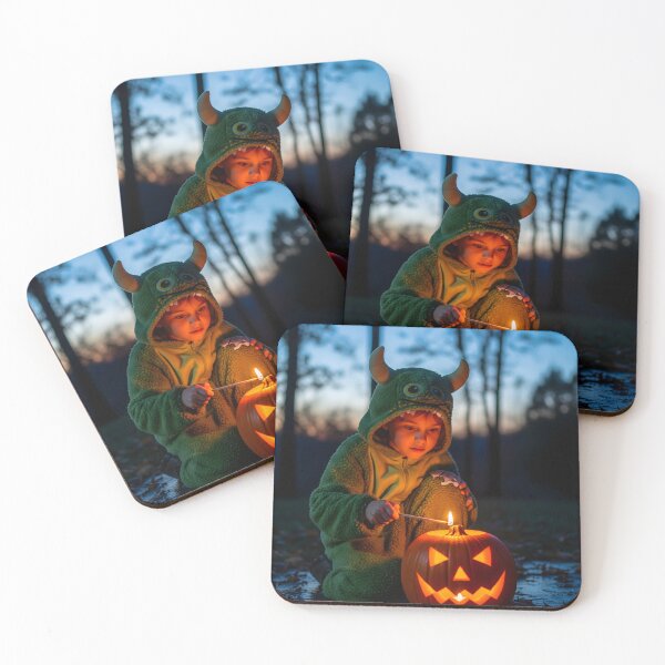 Item preview, A young child, appearing fascinated and curious, in a green monster costume lights a carved pumpkin in a yard at dusk, creating a magical feeling designed and sold by homydesign.