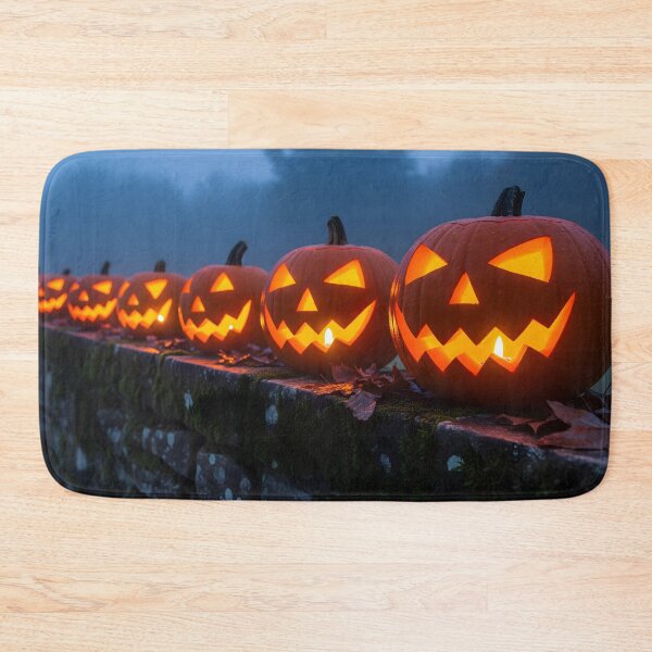 Item preview, A line of glowing carved pumpkins sits on a mossy stone wall on a foggy, dark night, creating a spooky and atmospheric scene designed and sold by homydesign.