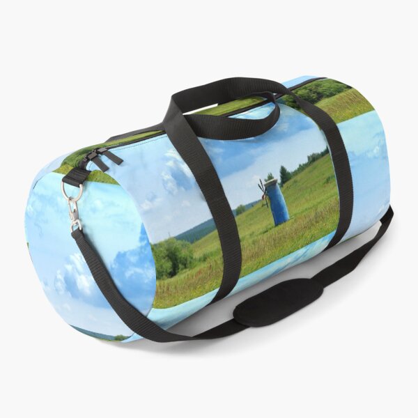 Item preview, Vibrant Blue Windmill in a Serene Countryside Meadow - Whimsical Landscape Photography designed and sold by Luminari Creations.