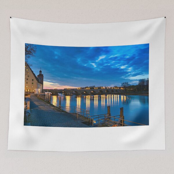 Item preview, Ancient stone bridge over the Danube river at night in Regensburg, Germany designed and sold by goceris.