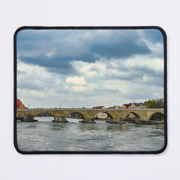 Item preview, Ancient stone bridge over the Danube river and clock tower in Regensburg, Bavaria, Germany designed and sold by goceris.