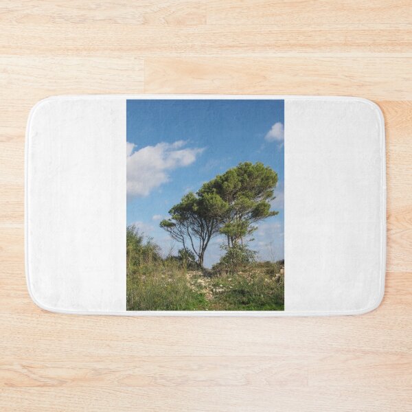 Item preview, Lone Pine Tree on Rocky Hilltop Under Bright Blue Sky with Scattered Clouds designed and sold by Nmallia.