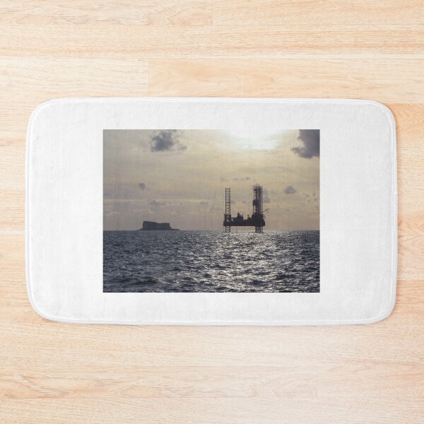 Item preview, Silhouette Of Offshore Oil Rig At Sunset With Small Island On The Horizon designed and sold by Nmallia.