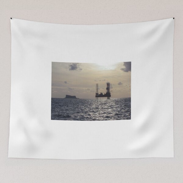 Item preview, Silhouette Of Offshore Oil Rig At Sunset With Small Island On The Horizon designed and sold by Nmallia.