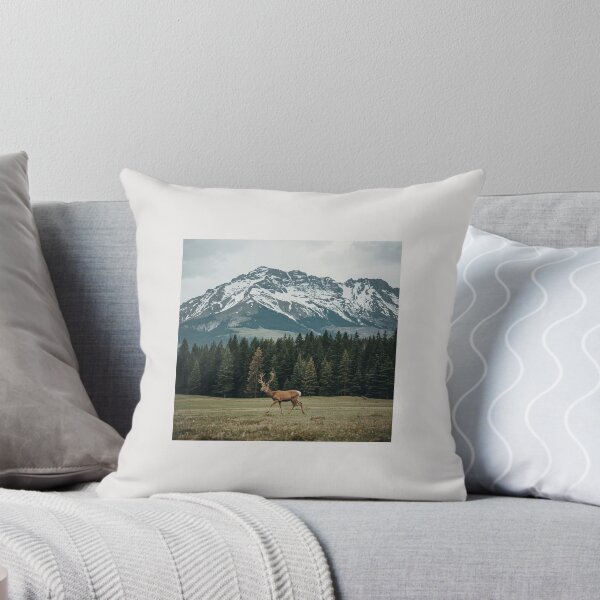 Item preview, A Deer Walking in a Forest Clearing with Snowy Mountains in the Background" designed and sold by The Natural Image.