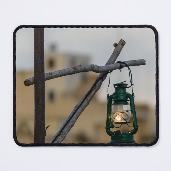 Item preview, Green Lantern Hanging From Rustic Wooden Frame With Blurred Urban Background designed and sold by Nmallia.