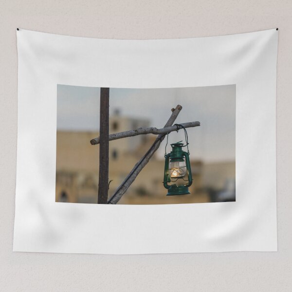 Item preview, Green Lantern Hanging From Rustic Wooden Frame With Blurred Urban Background designed and sold by Nmallia.