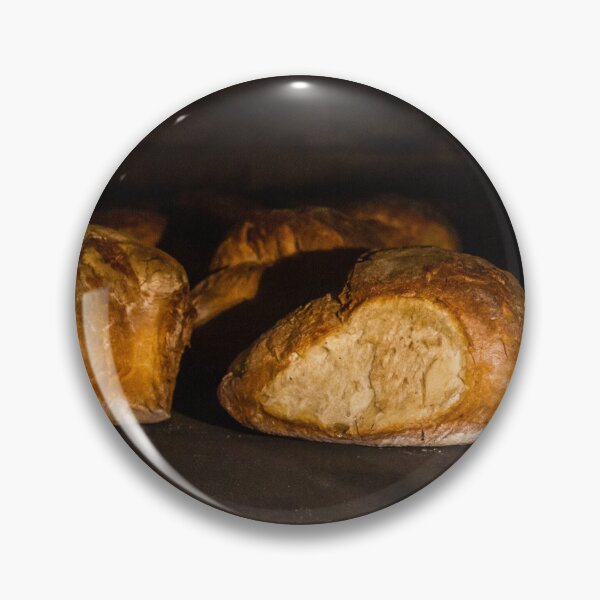 Item preview, Warm Baked Bread Rolls Resting On Dark Stone Surface In Low Lighting designed and sold by Nmallia.