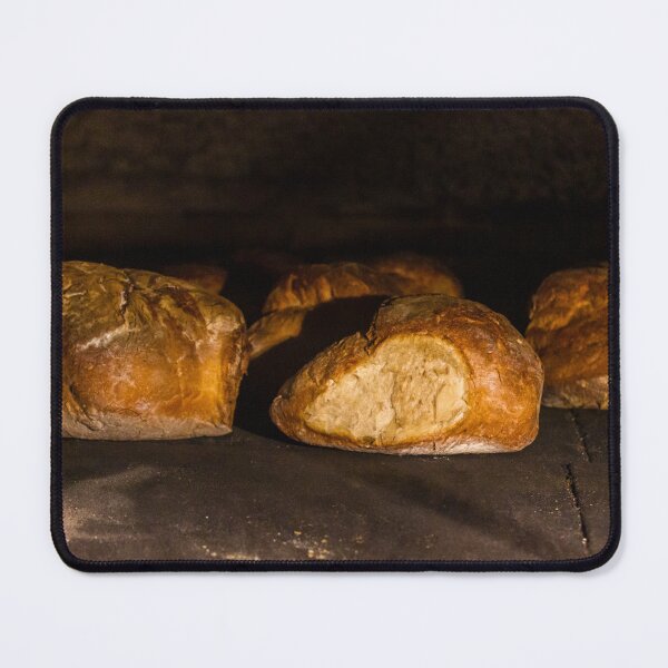 Item preview, Warm Baked Bread Rolls Resting On Dark Stone Surface In Low Lighting designed and sold by Nmallia.