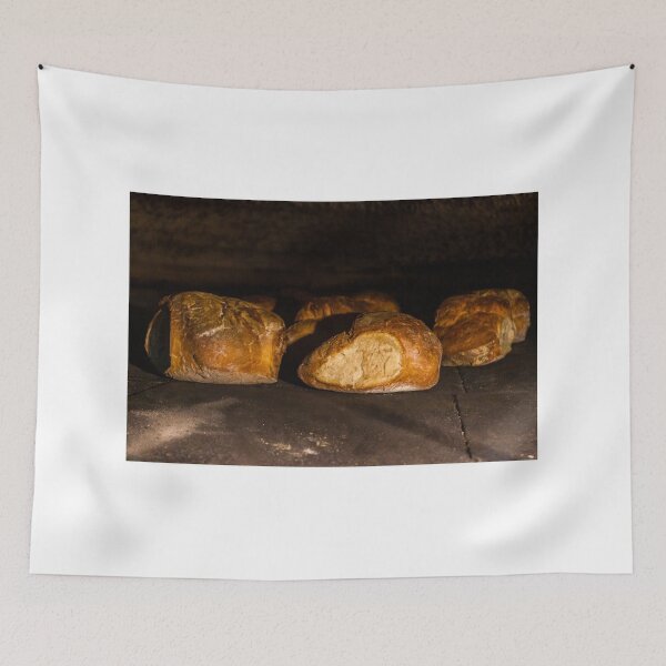 Item preview, Warm Baked Bread Rolls Resting On Dark Stone Surface In Low Lighting designed and sold by Nmallia.